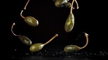 Pickled capers fall on the table. Filmed on a high-speed camera at 1000 fps. High quality FullHD footage video