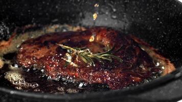 Beef steak in a pan with garlic and spices. Filmed on a high-speed camera at 1000 fps. High quality FullHD footage video