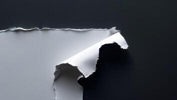 Ripped white paper edge with space for text on a black background photo