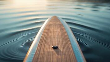A paddleboard is in the water with a wave photo
