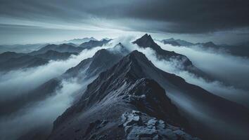 A mountain range is shown with clouds and dark clouds photo