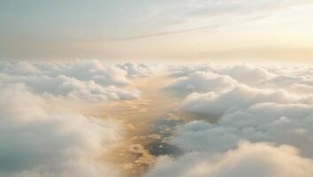 a illuminated scene over a valley of clouds, where the sky meets the earth in a blur of white and gold photo