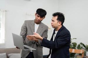 Business Communication and Collaboration. Two colleagues discussing project strategies in a relaxed office environment. photo