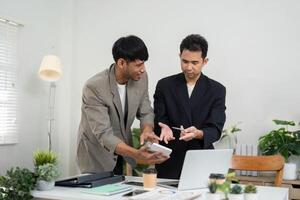 Collaboration and Innovation. Two professionals discussing ideas at a modern workspace, sharing insights on a project. photo
