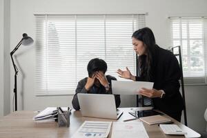 Business professional expressing frustration while discussing project issues with a colleague at the office. photo