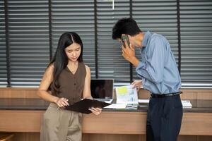 Business Interaction and Data Review. Young professionals discussing projects in a modern office setting. photo
