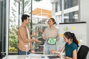 Sustainable Business Practices. Team presenting ESG initiatives in a collaborative workspace. photo