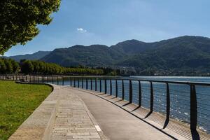 Lakeside Path with Railings and Mountain View near Lecco, lake Como photo