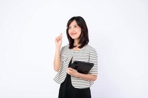 Southeast asian woman is small business owner in retail industry holding tablet and pen while thinking creatively about her online store startup with confidence and hope photo