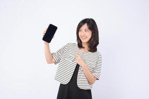 Southeast asian woman smiling and pointing at mobile phone screen showing internet application, demonstrating excitement and engagement with technology photo
