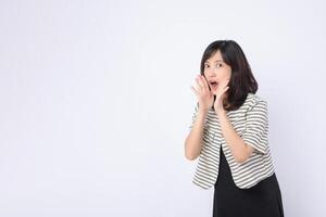 Southeast asian woman expressing surprise and excitement in advertising with striped jacket and black dress on white background photo