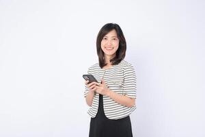 Southeast Asian woman smiling while using mobile phone for internet application in casual outfit on white background with positive expression and modern technology photo