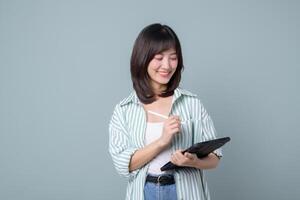 Southeast asian woman is small business owner working creatively on tablet for her online retail store startup in shopping and creative industry with happy expression photo