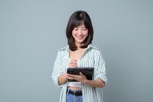 Southeast asian woman is small business owner working creatively on tablet for her online retail startup store in shopping and creative industry with happy expression photo