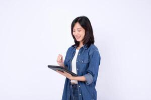 Southeast asian woman is smiling while using digital tablet for her small business startup in creative retail industry managing online store and shopping tasks confidently photo