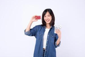 Southeast asian woman happily holds mobile phone and credit card while using internet application for online payment and financial management in casual setting photo