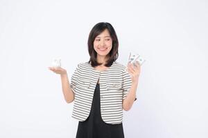 Southeast asian woman is happily shopping online while holding cash and piggy bank showing smart money management and joyful financial planning photo