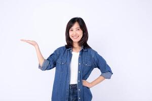 Southeast asian woman smiling confidently in casual denim clothing advertising with open hand gesture on white background photo