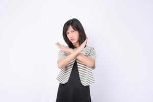 Southeast asian woman shows serious expression with crossed arms in gesture of refusal or advertising no sign in plain background photo