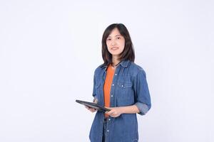 Southeast asian woman is small business owner working creatively in retail and online store startup industry using tablet for shopping and managing her business photo
