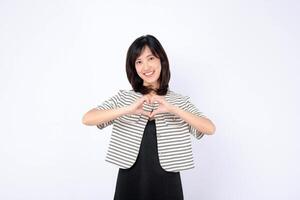 Southeast asian woman smiling warmly and making heart shape with her hands for advertising and positive connection photo