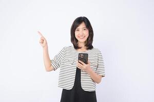 Southeast asian woman smiling while holding mobile phone and pointing up with her finger showing internet application usage in bright studio setting photo