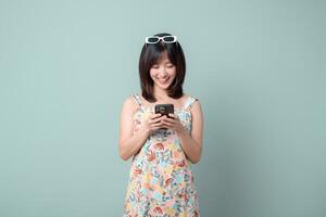 Southeast asian woman happily uses mobile phone to explore internet application, enjoying convenience and connection it brings to her daily life photo