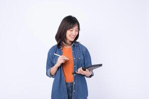 Southeast asian woman is small business owner working creatively on her online store using digital tablet in retail and startup industry with happy and focused expression photo