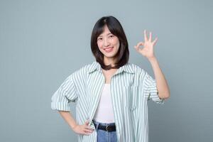 Southeast asian woman shows okay gesture with smile representing small business owner in retail and creative industry for startup online store concept photo
