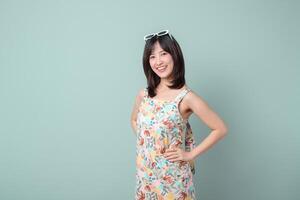 Southeast asian woman smiles confidently wearing colorful dress and sunglasses showing creative spirit as small business owner in retail and online store startup industry shopping photo
