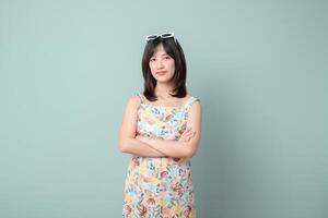 Southeast asian woman stands confidently with arms crossed wearing floral dress and sunglasses on her head representing small business owner in creative retail industry startup online store photo