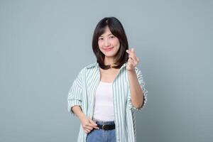 Southeast asian woman smiles creatively showing small heart gesture symbolizing love for her retail business and online startup store in creative industry of shopping photo