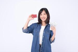 Southeast Asian woman smiling and holding credit card and cash money showing internet banking and mobile payment application concept with happy expression photo