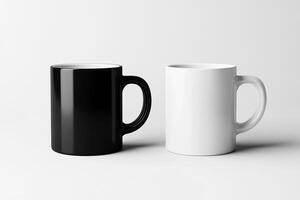 Glossy black and white mugs with handles displayed together on a smooth light surface for contrast photo