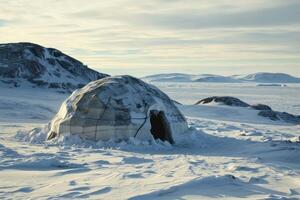 A warm, flickering light shines from within an igloo, surrounded by endless snowy plains. photo