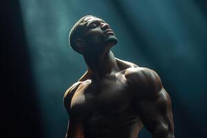 Muscular Man Poses Dramatically in Spotlight, Showcasing Strength and Confidence in a Dimly Lit Environment photo