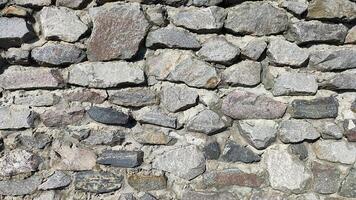 rustic gray stone wall texture, a natural and textured background perfect for architectural visualizations and organic design elements photo
