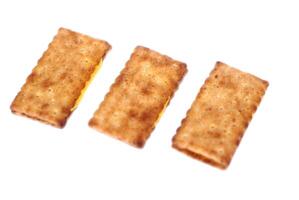 Three crispy biscuit crackers, beautifully arranged and isolated on a clean white background. Concept, a tasty and satisfying snack choice,perfectly crafted for moments of delight anytime, anywhere. photo