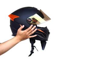 Close up hands hold helmet, isolated on white background. Concept, safety in transportation. Helmet helps prevent head injuries in accidents. Campaign to wear helmet when riding a motorcycle. photo