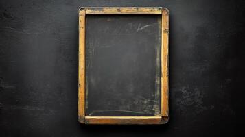 Old wooden frame on black wall photo
