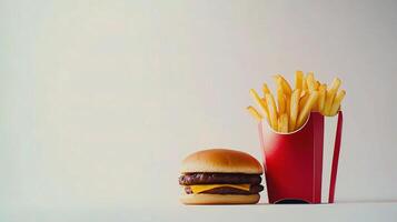 A hamburger and french fries in a red container photo
