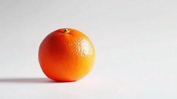 A single orange on a white surface photo