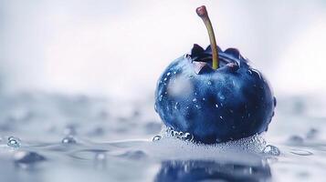A blueberry on a surface with water droplets photo