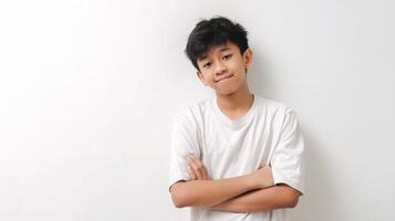 A young boy in a white t - shirt standing with his arms crossed photo