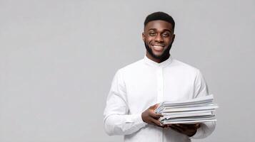 A young man is holding a stack of papers photo