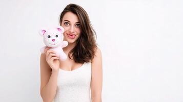 A woman holding a pink teddy bear photo