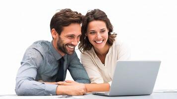A man and woman smiling while looking at a laptop photo