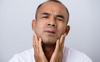 Man has facial swelling an allergic reaction to triggers such as insect bites stings photo