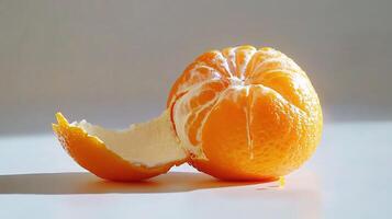 A peeled orange with a bite taken out of it photo