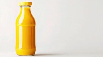 A bottle of orange juice sitting on a table photo